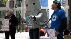 OAKLAND, CALIFORNIA - APRIL 27: Demonstrators protest against AI outside the courthouse at the Ronald V. Dellums Federal Building as jury selection begins in the lawsuit between Elon Musk and OpenAI on April 27, 2026 in Oakland, California. Elon Musk invested in OpenAI early on believing it would be a non-profit, but is now suing OpenAI and its CEO Sam Altman for allegedly deceiving him by developing OpenAI into a for-profit company. (Photo by Benjamin Fanjoy/Getty Images)