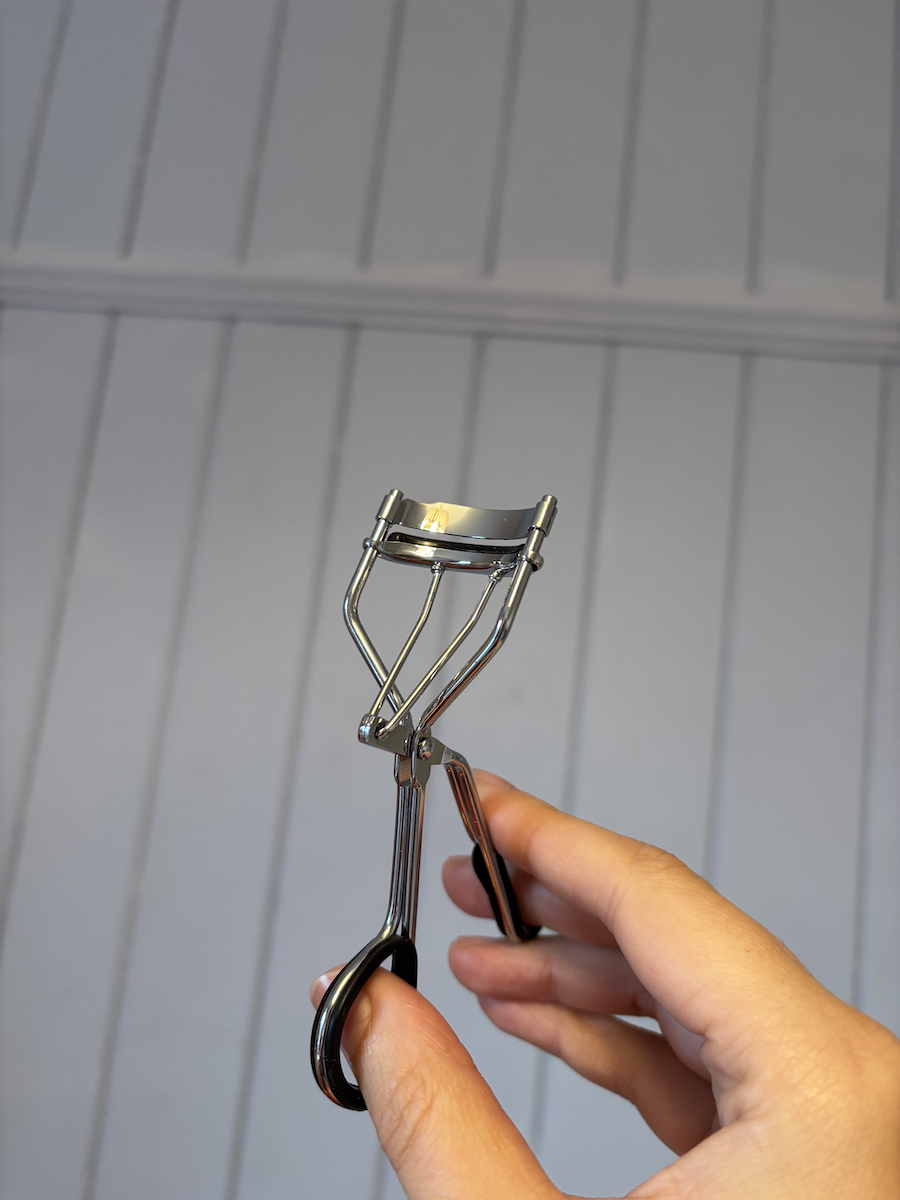 Mica Ricketts holding eyelash curler