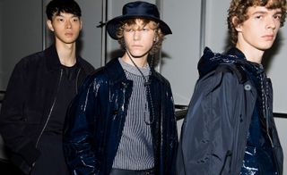 Models wear navy jackets, t-shirt, striped knit and bucket hat