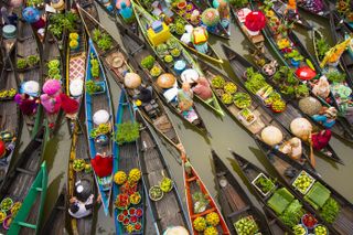 Locals gather to buy and sell fresh fruit, vegetables and spices at a floating market in Banjarmasin, Indonesia