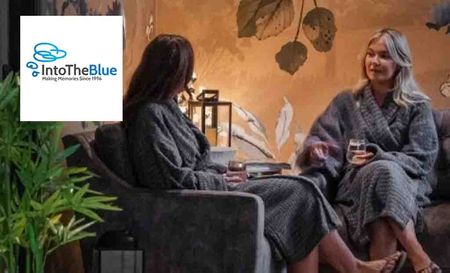 into the blue logo top left with two women sitting in dressing gowns talking in low light