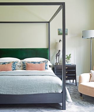 bedroom with black four poster with green headboard
