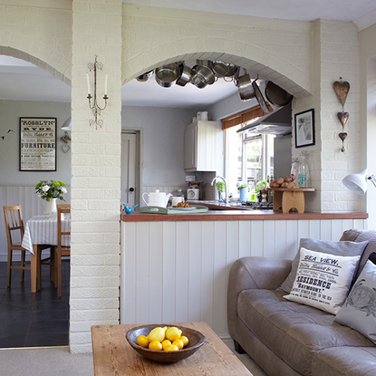 open plan kitchen with cabinet and wooden table