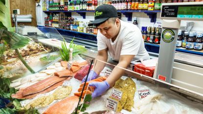 A fishmonger is seen at a store in Delray Beach, Florida.