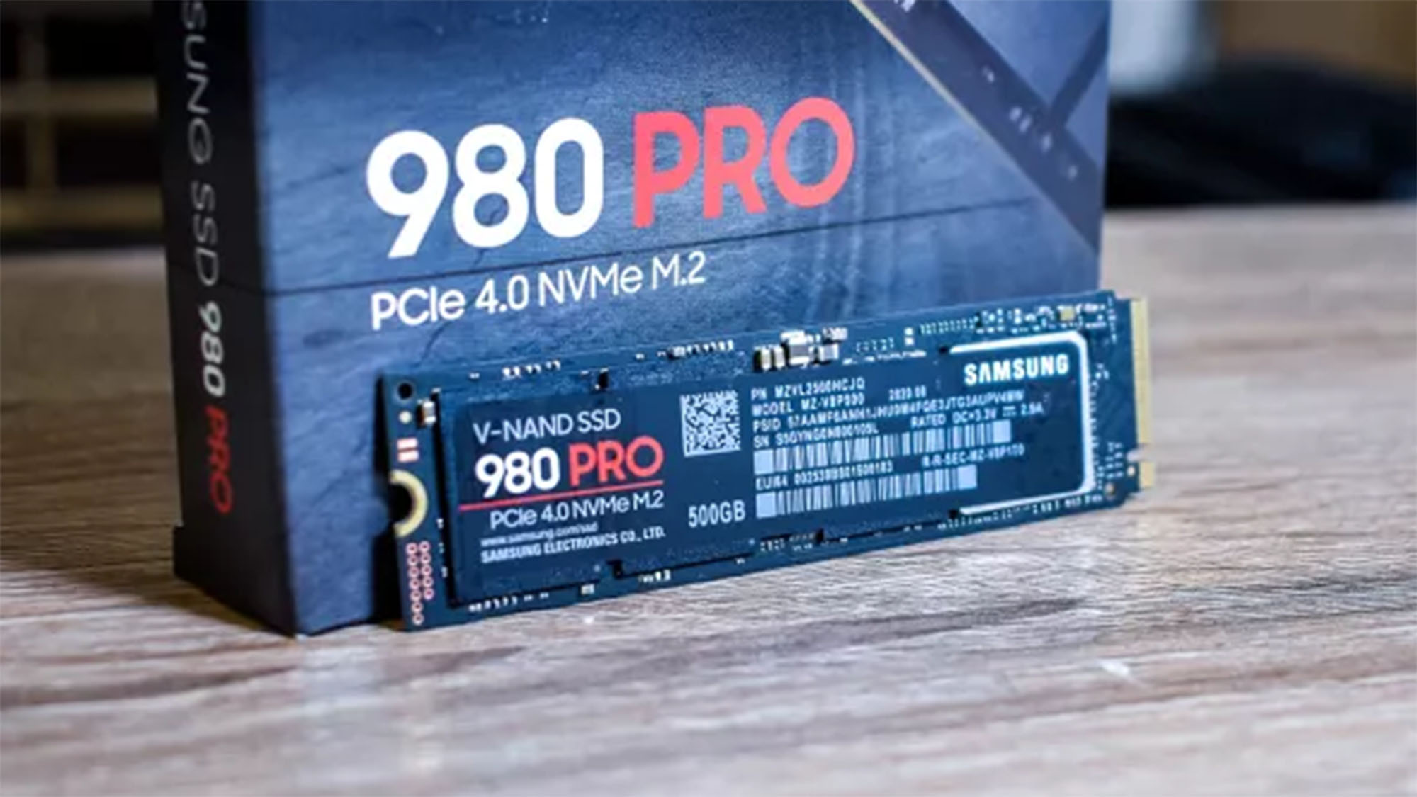 A Samsung 980 Pro SSD on a table in front of its packaging