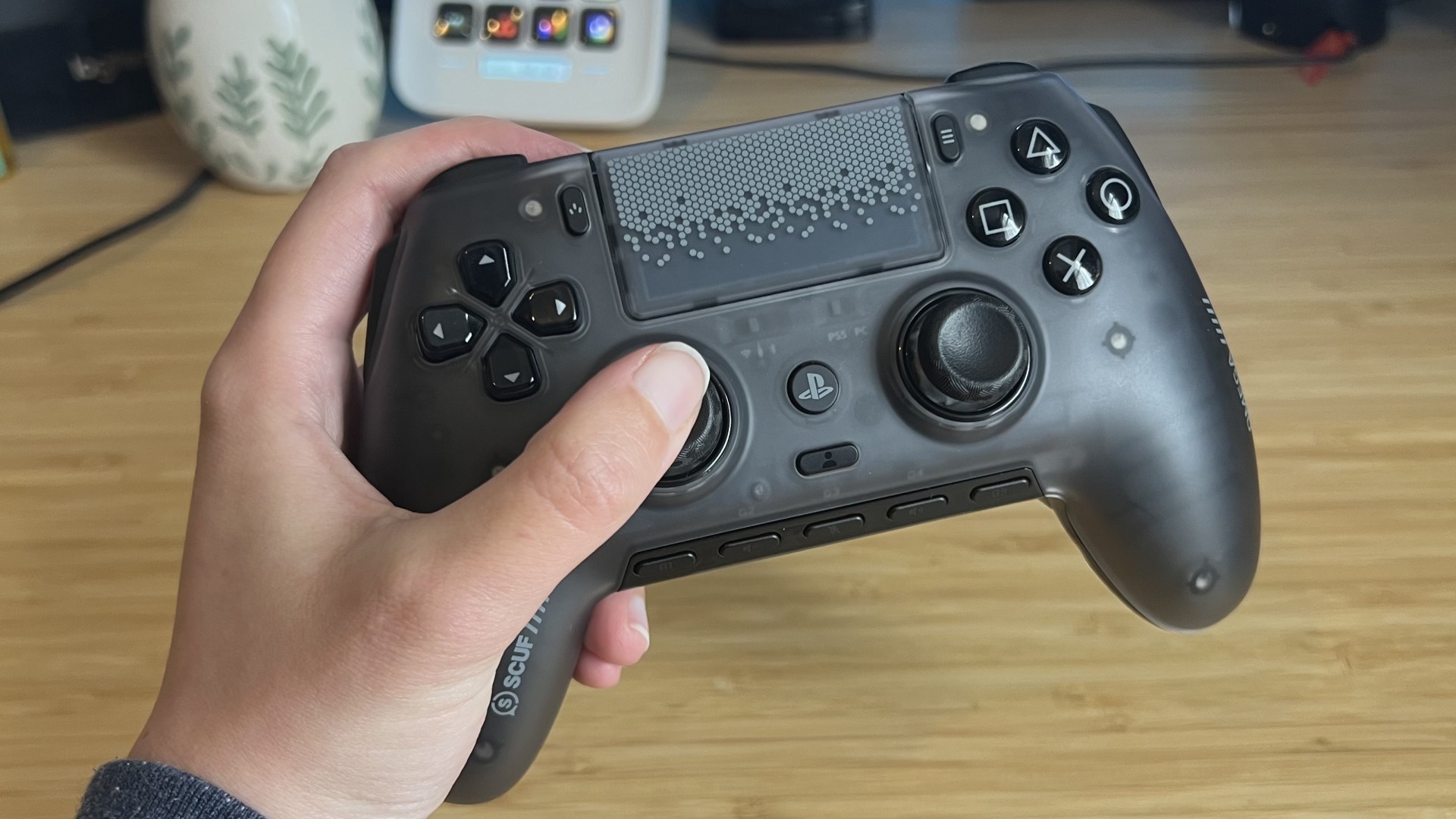 Hand holding Scuf Omega PS5 controller