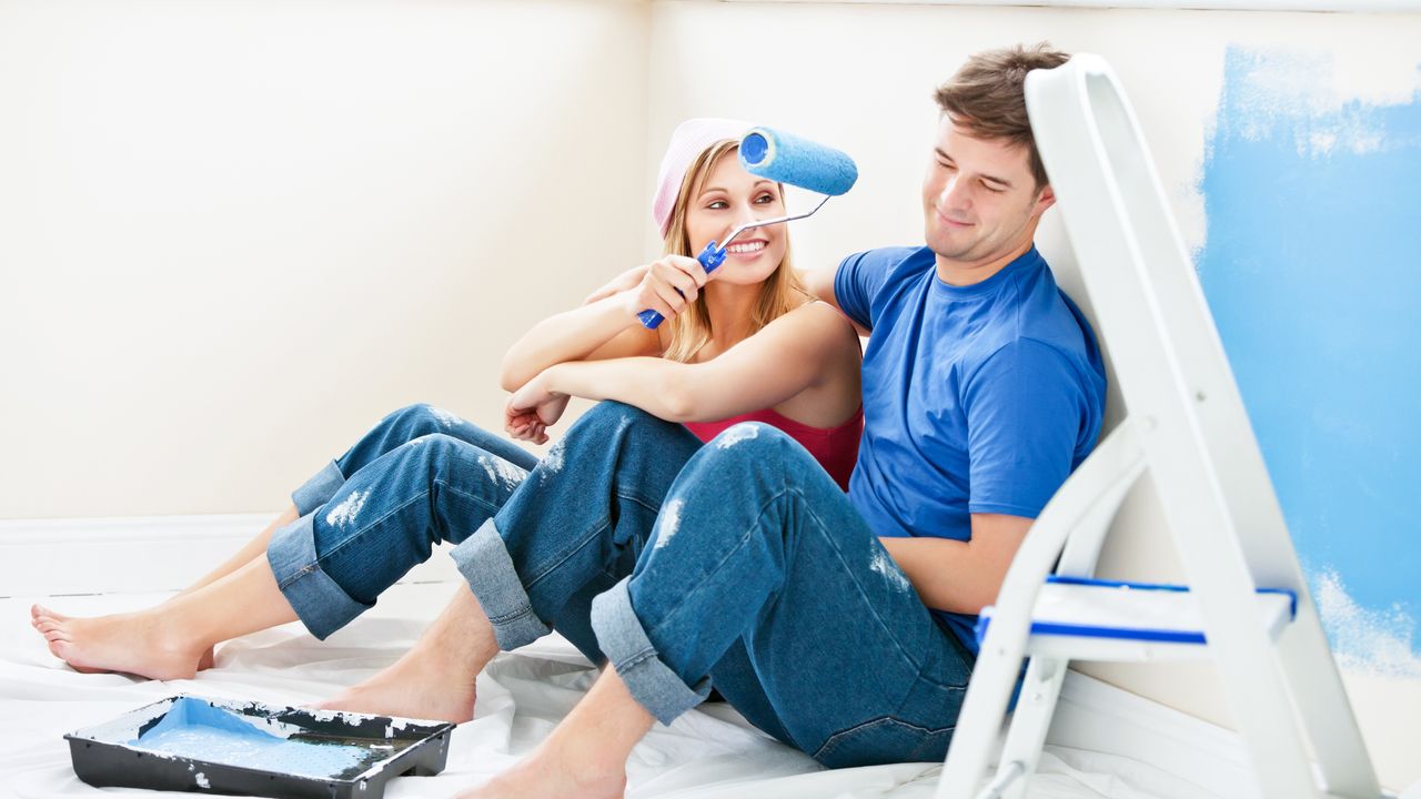 couple painting with blue paint