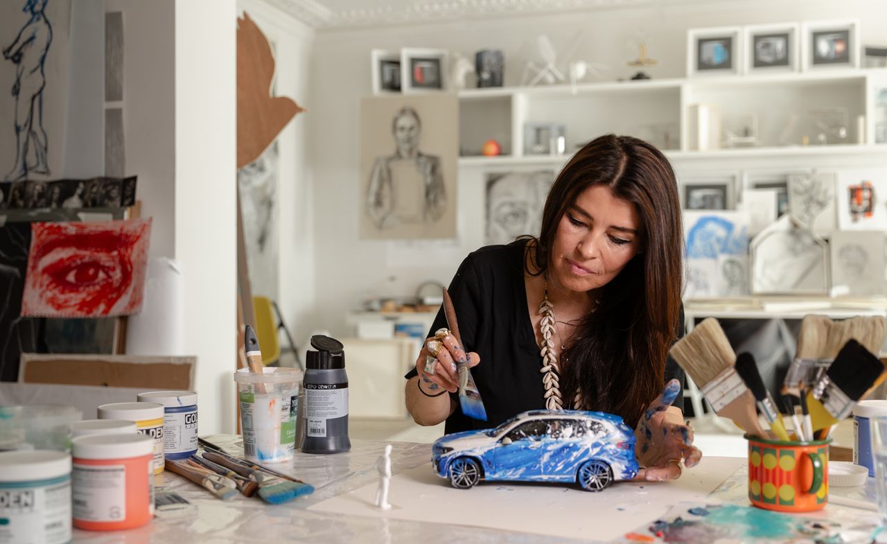 Artist Es Devlin painting a small model car in her studio ahead of Es Devlin BMW installations at Art Basel 2024