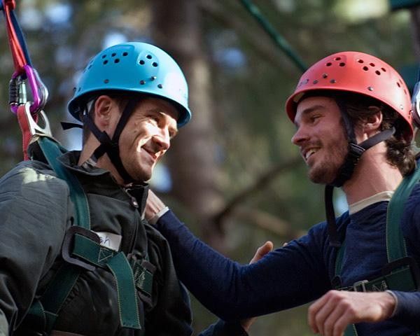Josh Thornton and Dan Timmerman share a laugh after completing a challenge more than 3 stories off the ground.