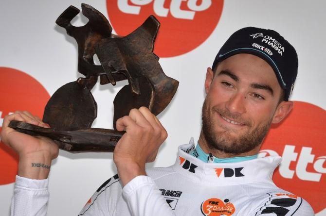 Belgium's Guillaume van Keirsbulck of team Omega Pharma - Quick Step celebrates holding his trophy on the podium after winning the Three Days of De Panne