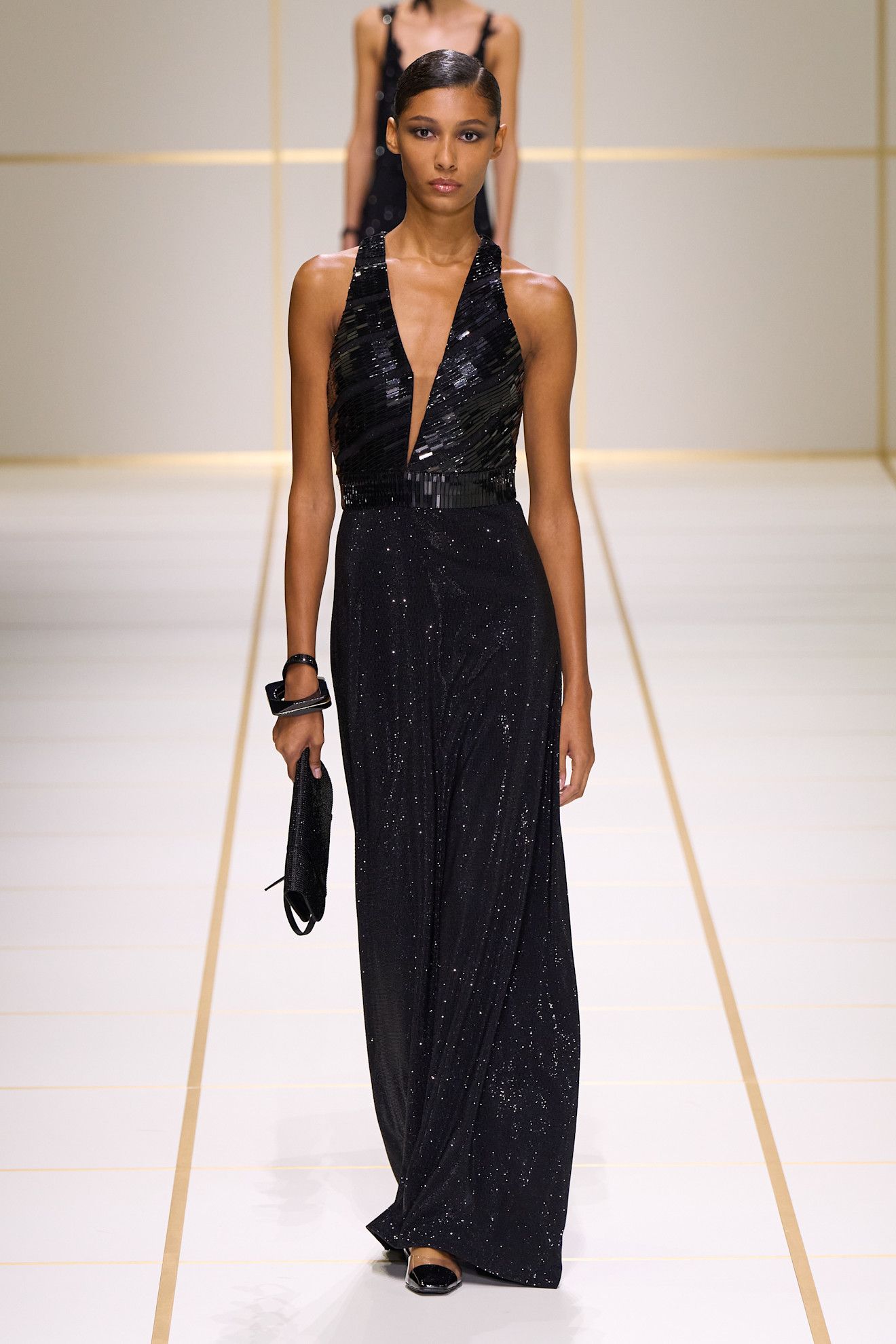 a model walks the giorgio armani s/s 27 runway.