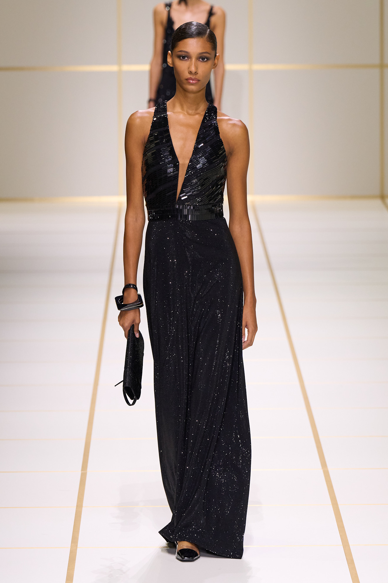 a model walks the giorgio armani s/s 27 runway.