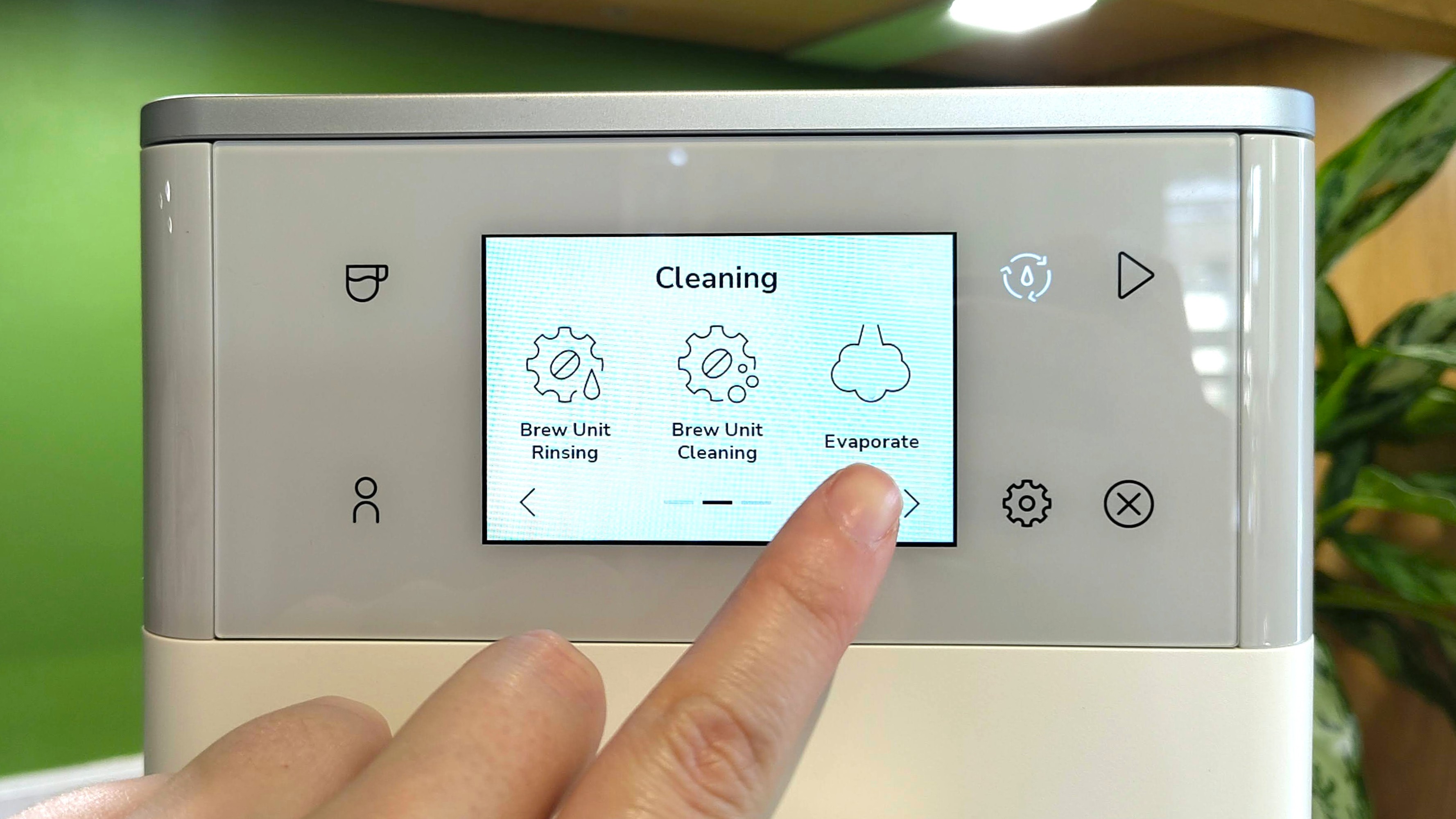 Person selecting 'Evaporate' option on KitchenAid KF4 espresso machine