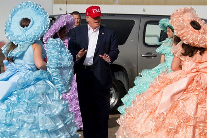President-elect Donald Trump greets members of the Azalea Trail Maids as he arrives in Mobile, Alabama