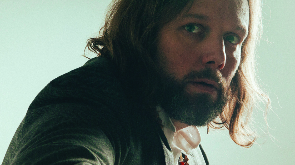 Rich Robinson in a green jacket looking at the camera.