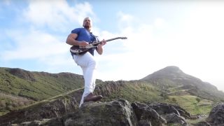 Joe Hendry playing a guitar in the "I Believe in Joe Hendry" music video