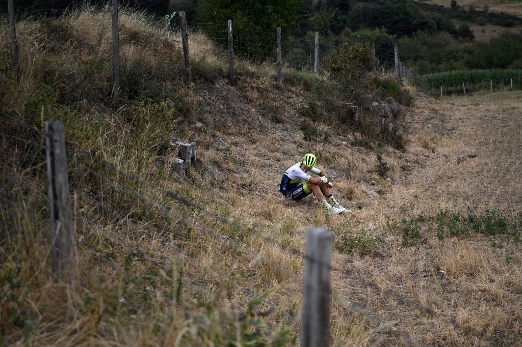 Team Wanty rider Belgiums Quinten Hermans sits in a field after falling during the first stage of the 72nd edition of the Criterium du Dauphine cycling race 2185 km between ClermontFerrand and SaintChristoenJarez on August 12 2020 Photo by AnneChristine POUJOULAT AFP Photo by ANNECHRISTINE POUJOULATAFP via Getty Images