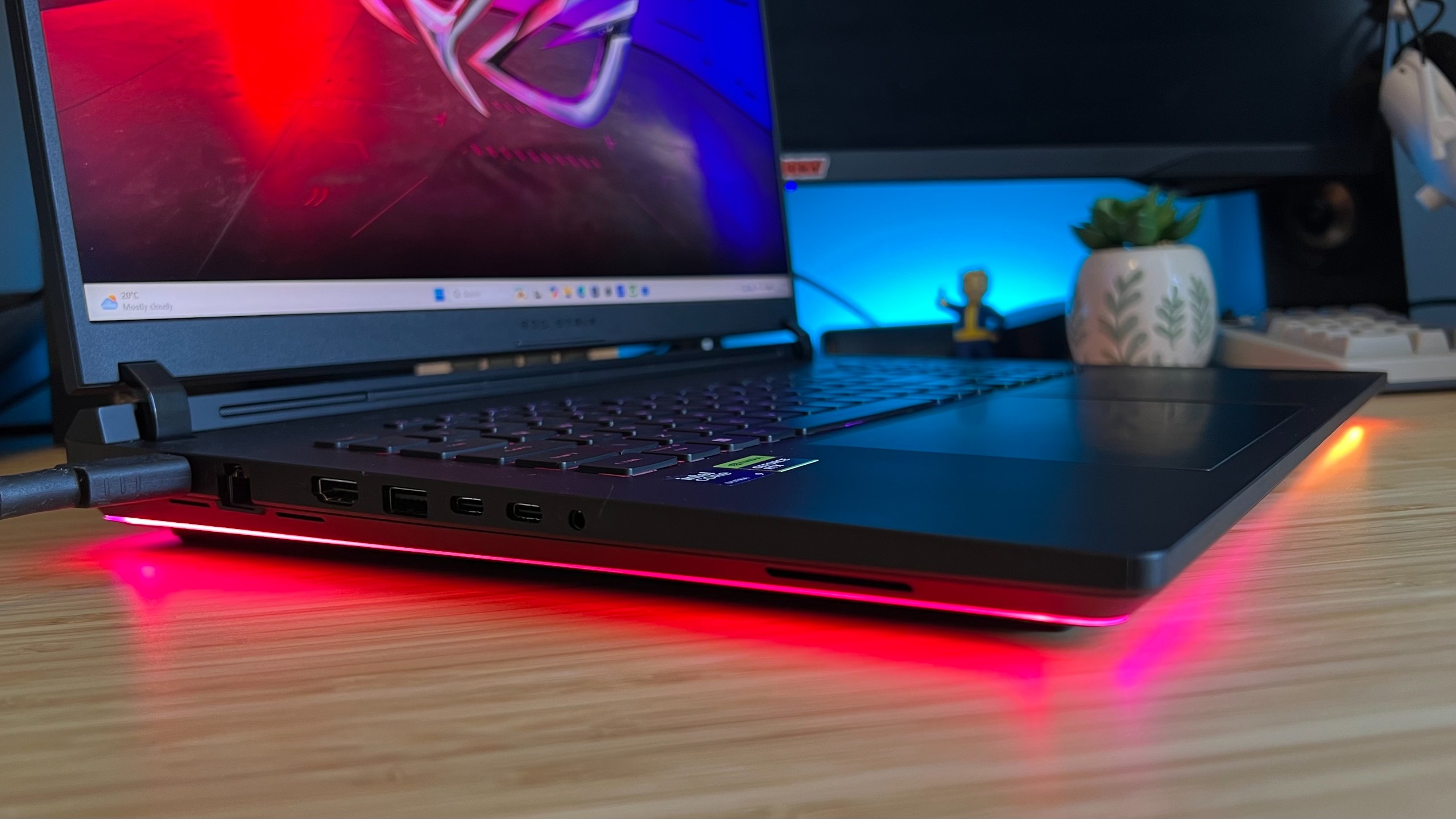 Side view of Asus ROG Strix Scar 18 gaming laptop showing thickness and RGB strip lighting