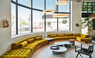 Yellow sofa by a window in Holly Hunt showroom Los Angeles