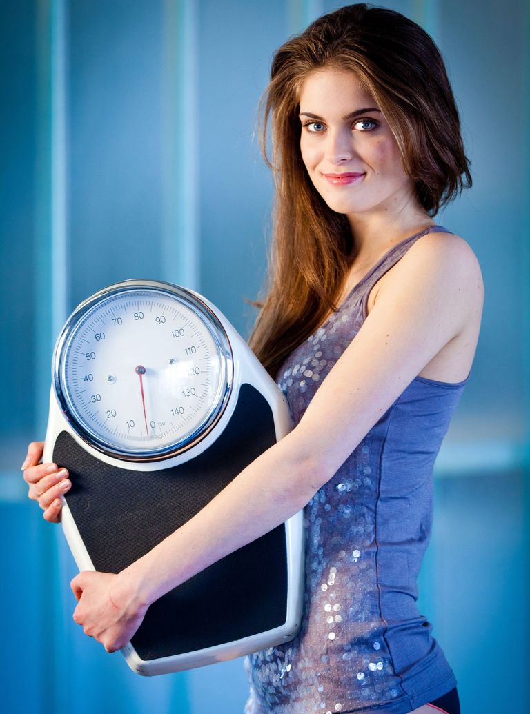 woman holding scales-alternate day fasting diet