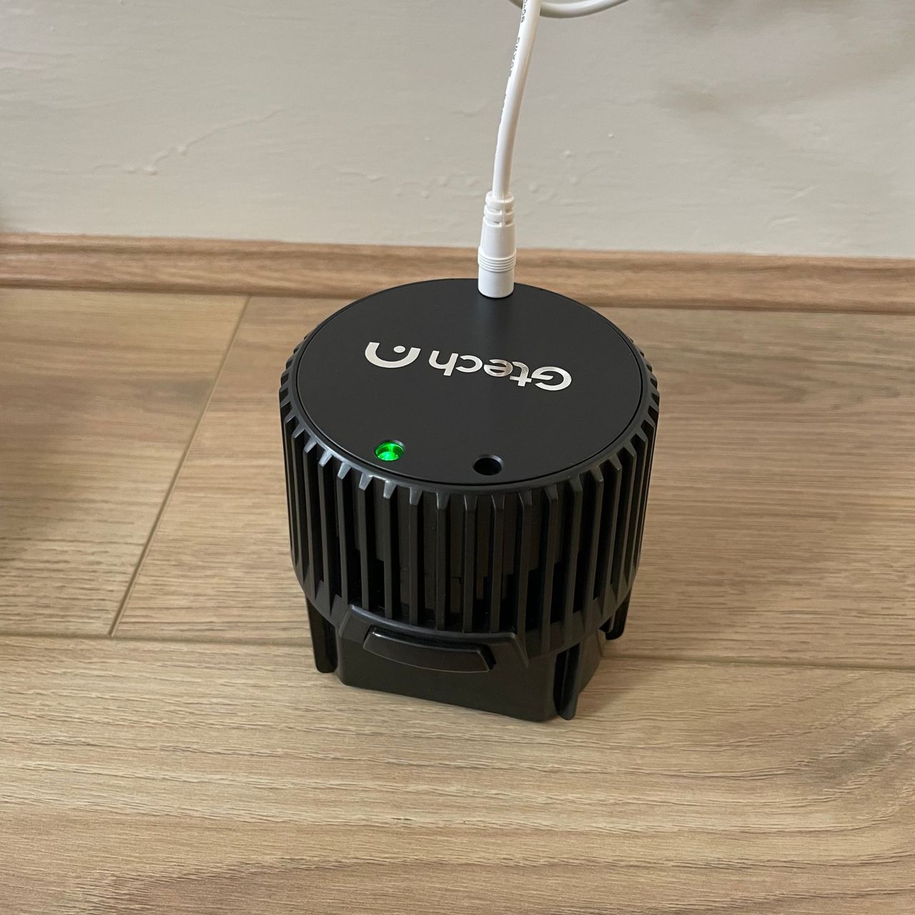 Gtech AirFOX Platinum Cordless Vacuum battery charging on the floor