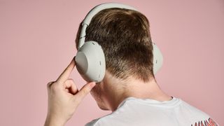 Man turning on the Sony WH-1000XM6