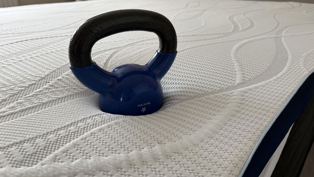 A 5kg weight on the surface of the DreamCloud Softer mattress topper