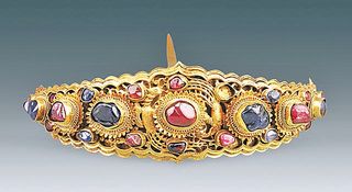 A gold hairpin, decorated with a mix of sapphires and rubies, found inside the Ming Dynasty tomb of a woman named Lady Mei.