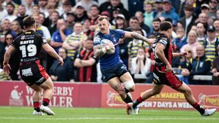 Wakefield Trinity winger Tom Johnstone running with the ball against the Warrington Wolves in the 2026 Super League