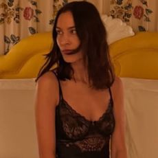 Alexa Chung in London wearing a lace slip dress with high heels.