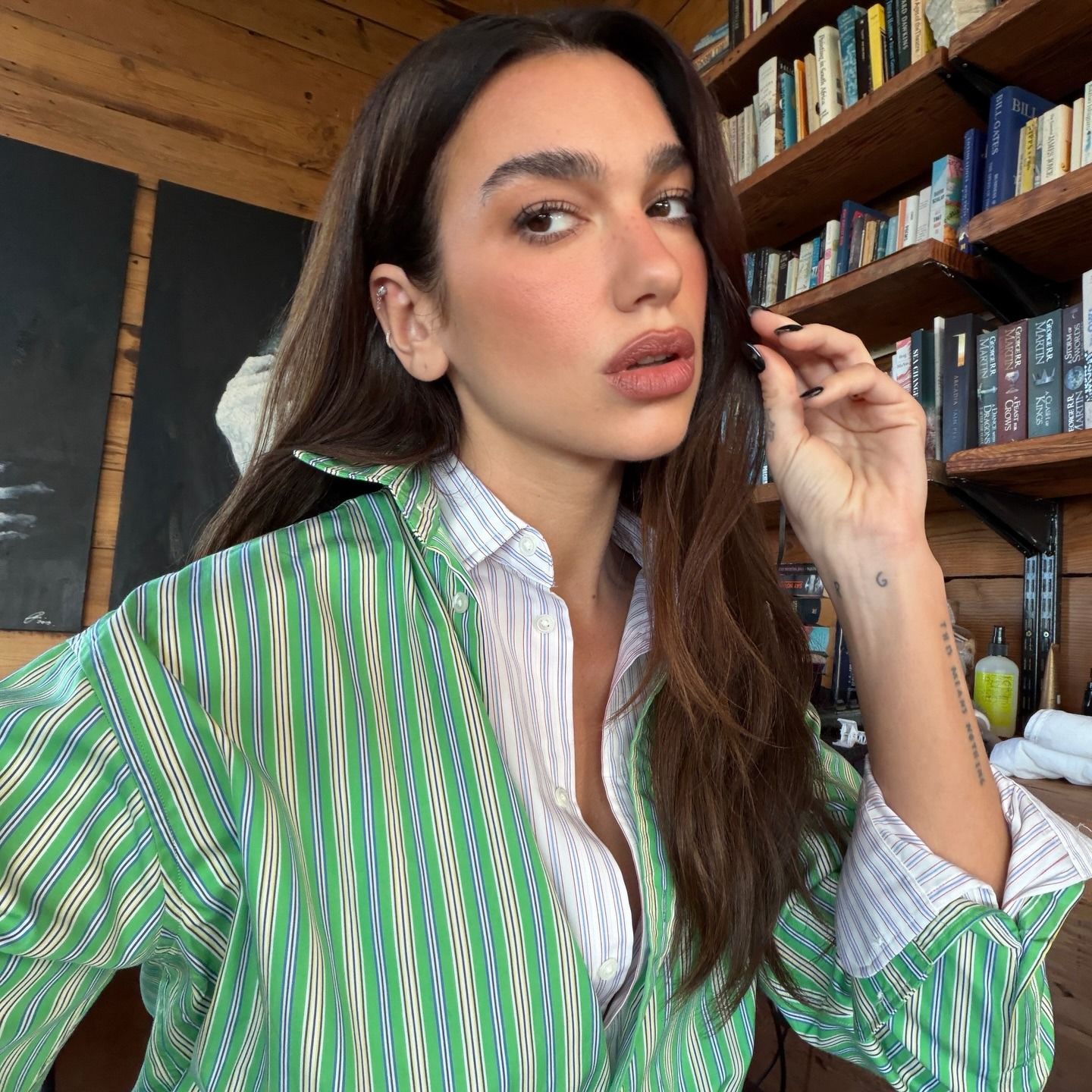 Dua Lipa wearing two button-down shirts.
