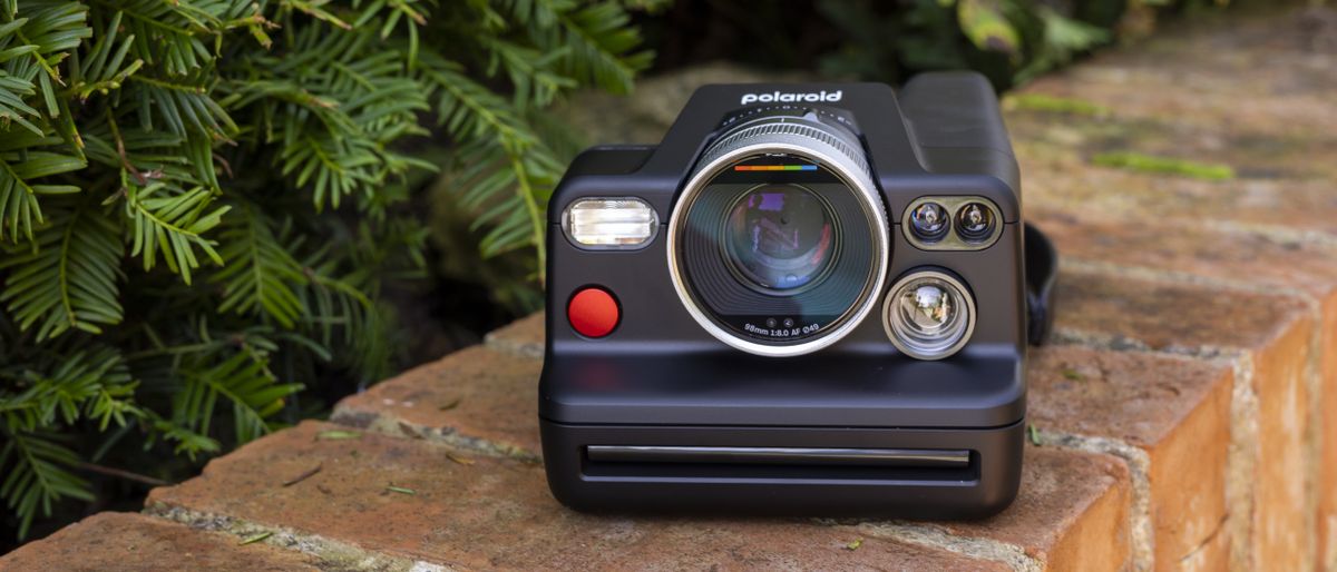 The Polaroid I-2 instant camera on a brick wall in the sunshine