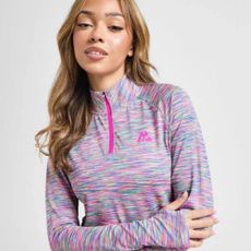 Young woman wearing multi-coloured sports jacket from JD Sports.