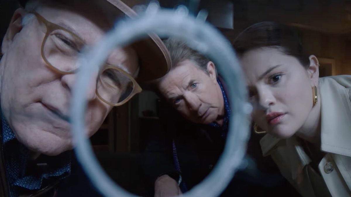 Steve Martin, Martin Short and Selena Gomez looking through bullet hole in window