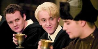 Tom Felton as Draco Malfoy holding a goblet