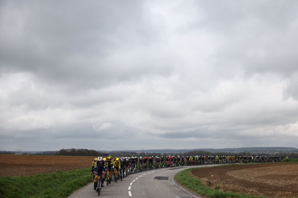 The pack of riders cycles during the 2nd stage of the Paris-Nice cycling race, 183,9 km between Montesson and Bellegarde, on March 10, 2025. (Photo by Anne-Christine POUJOULAT / AFP)
