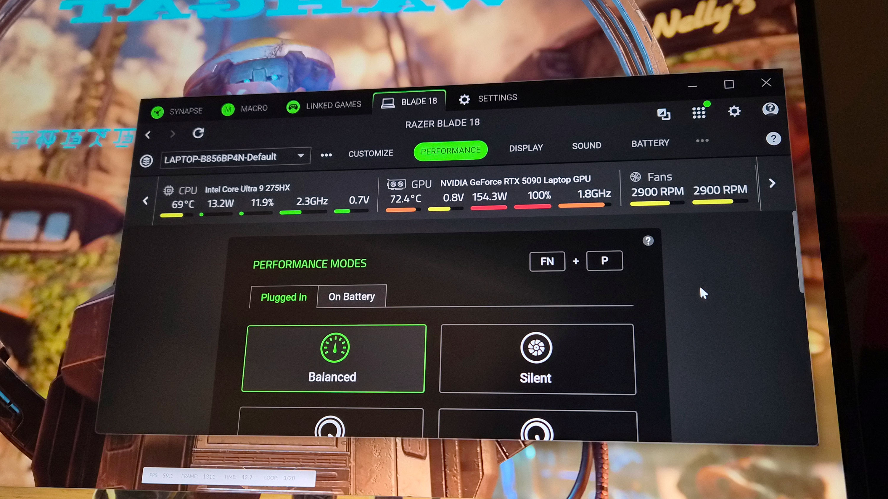 Razer Blade 18 (2025) gaming laptop showing temperatures in Razer Synapse app during a 3DMark benchmarking program.