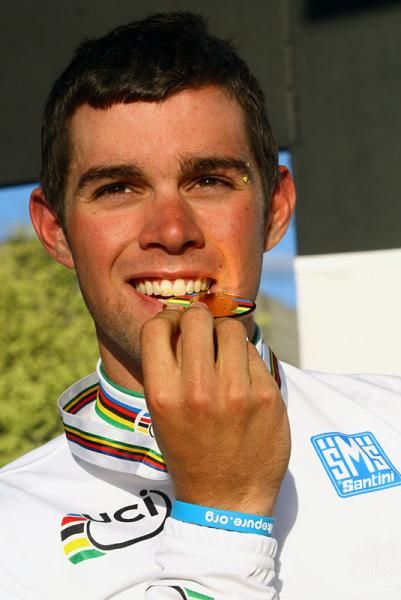 Australia's Michael Matthews takes a bite of his gold medal.