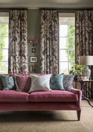 living room with pink sofa, grey walls, floral curtains, coir flooring