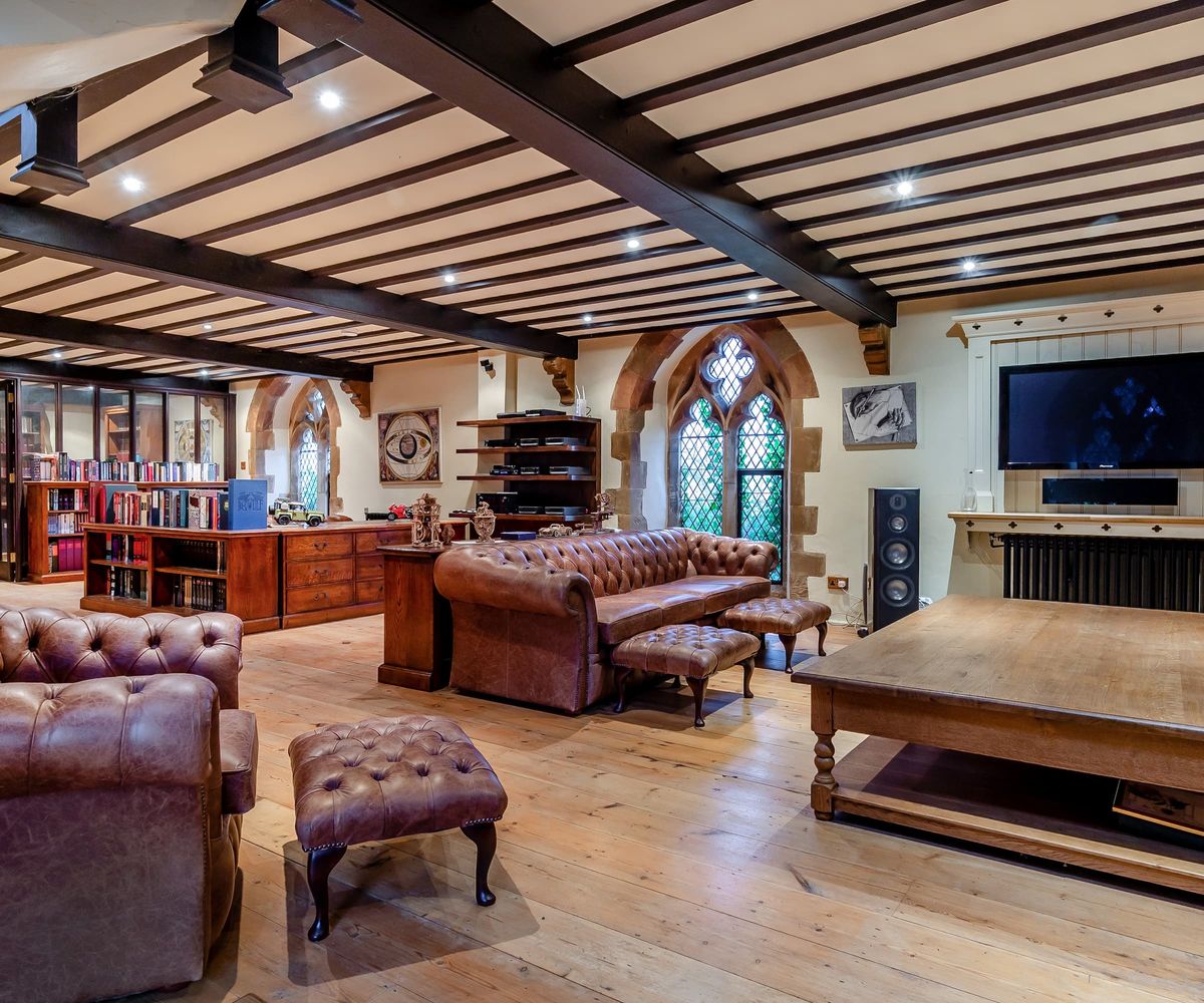 A living room with a connecting library