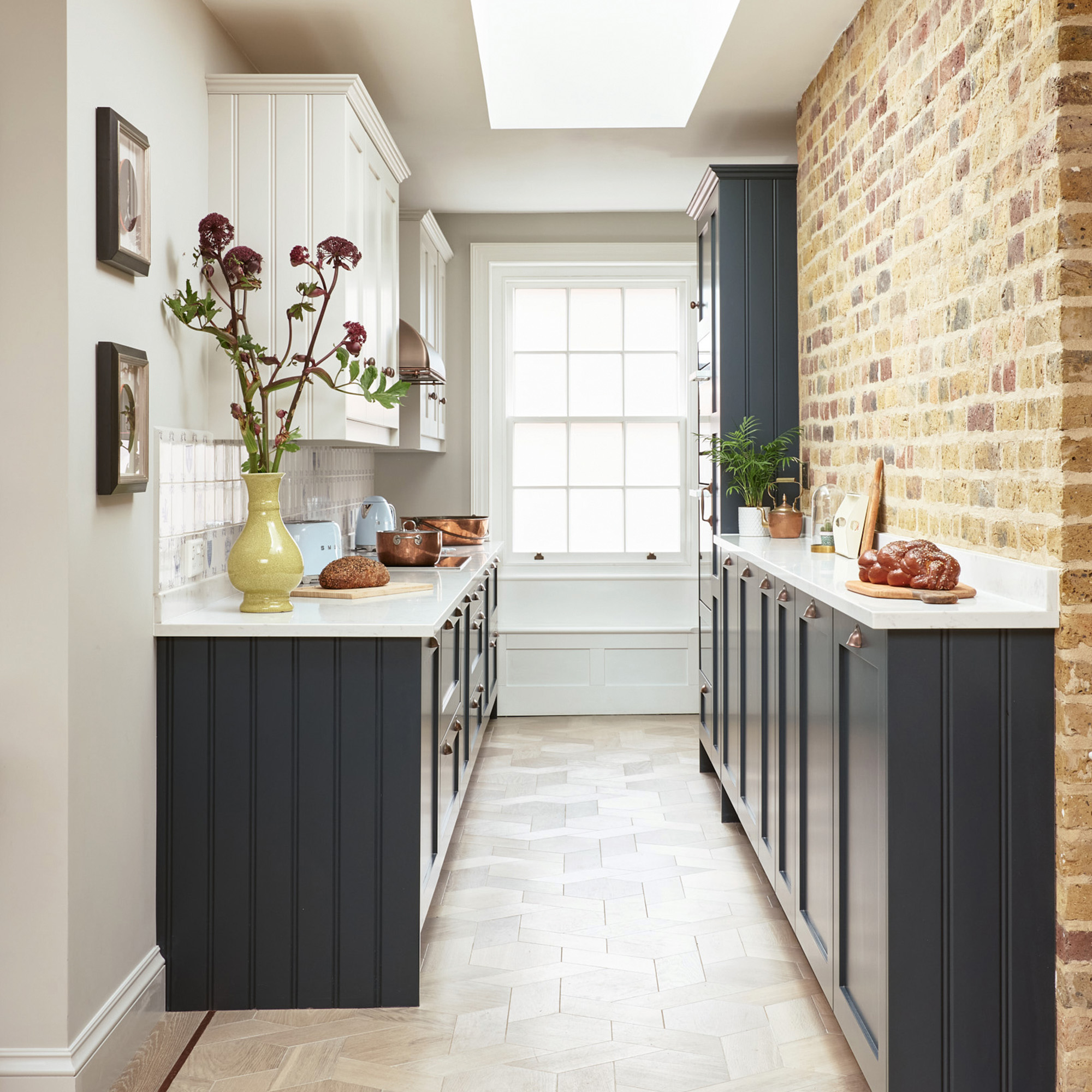 galley kitchen with navy cabinets and one run of slim-line cabinets and white wall cabinets john lewis of hungerford