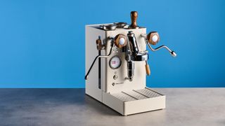 the lelit mara x3 in white and walnut photographed against a blue tom's guide background