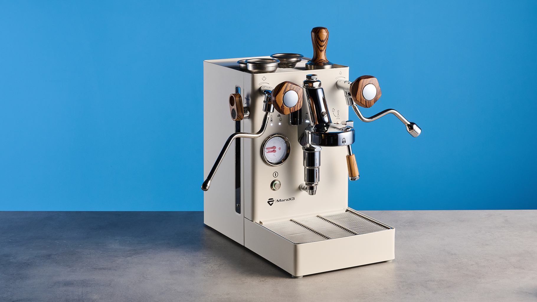 the lelit mara x3 in white and walnut photographed against a blue tom's guide background