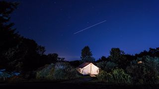 A Firelight Camps tent at night in the woods of Ithaca, New York