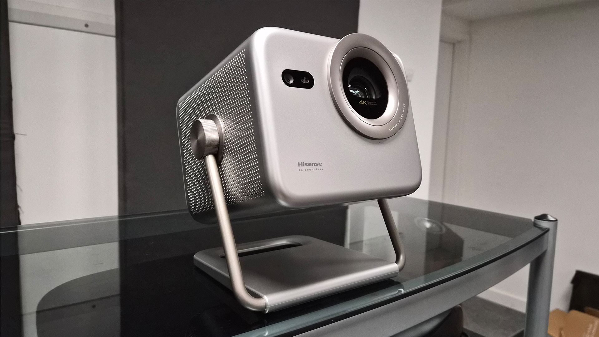 Hisense M2 Pro lifestyle projector on glass coffee table, slight angle
