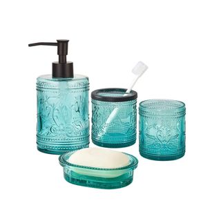 A set of four blue glass bathroom accessories