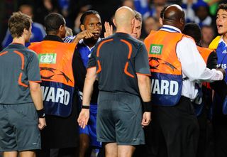 Chelsea players including Didier Drogba (left) and head coach Gus Hiddink complain to the referee Tom Henning Ovrebo after the final whistle during the Chelsea v Barcelona Champions League semi-final 2nd leg match at Stamford Bridge on May 6th 2009 in London (Photo by Tom Jenkins/Getty Images)