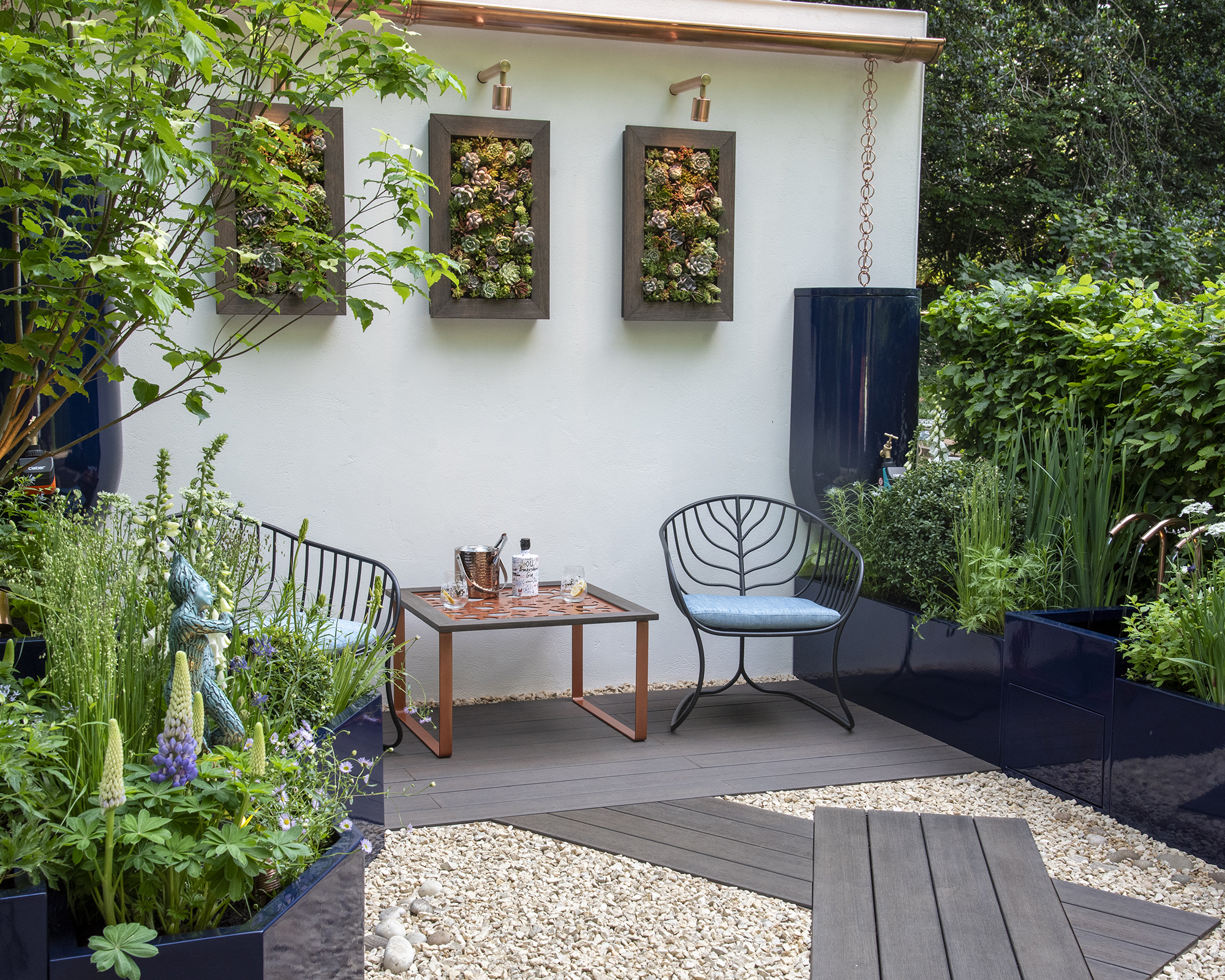 Rain chains harvest rainwater and feed to interconnected planters in the Water Saving Garden at Cheslea Flower Show 2024