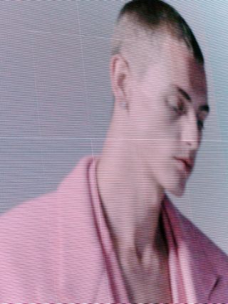 Model's head and shoulders, with pink coat