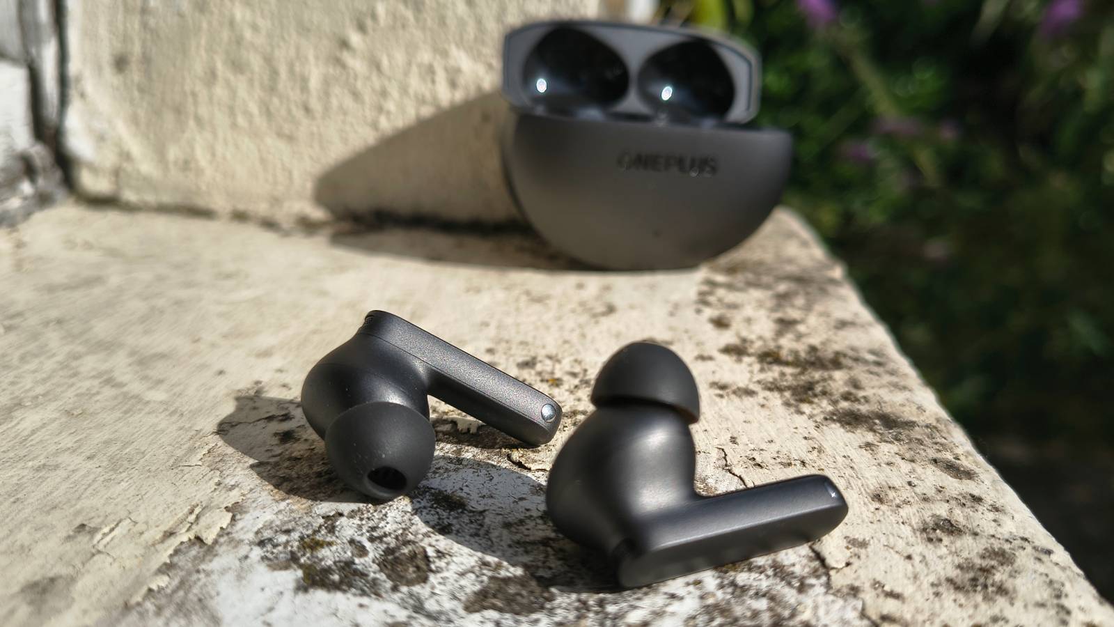 The OnePlus Buds 4 on a window sill.